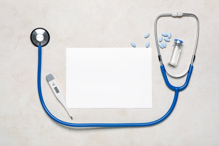 Blank card, stethoscope, thermometer and medicines on light background. melanoma conceptの写真素材