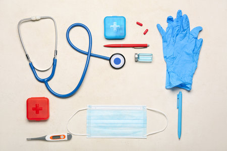 Frame made of stethoscope, thermometer, medical mask, gloves and medicines on light background. melanoma conceptの写真素材