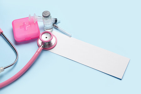 Blank sheet of paper, stethoscope, ampule and syringe on color background. melanoma conceptの写真素材