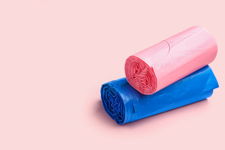 Different rolls of garbage bags on pink backgroundの写真素材