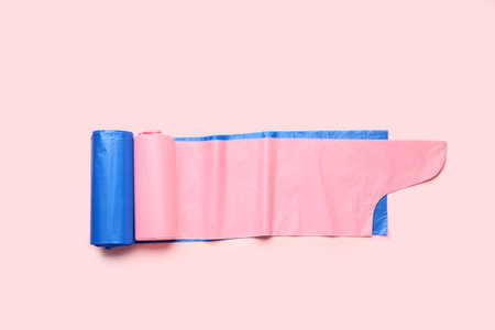 Different rolls of garbage bags on pink backgroundの写真素材