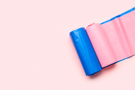Different rolls of garbage bags on pink backgroundの写真素材