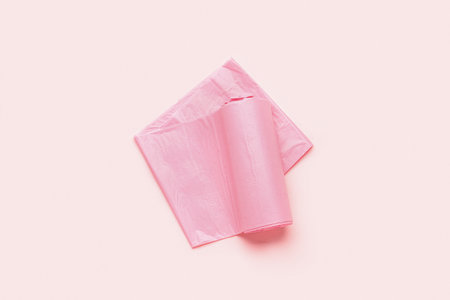 Roll of garbage bags on pink backgroundの写真素材