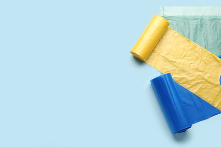Different rolls of garbage bags on blue backgroundの写真素材