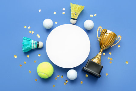 Blank card with gold cup, balls and confetti on blue backgroundの写真素材