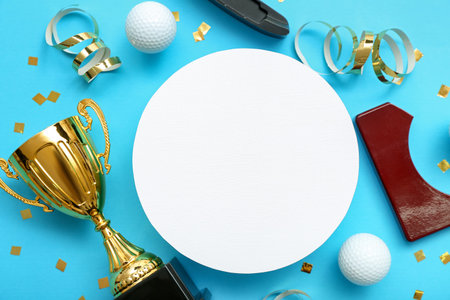 Blank card with gold cup, golf club, balls and confetti on blue backgroundの写真素材