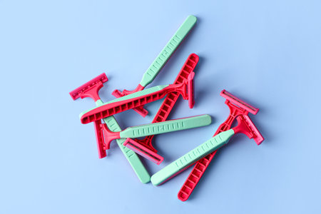 Heap of colorful safety razors on color backgroundの写真素材