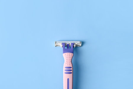 Razor hair removal on color backgroundの写真素材