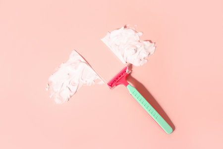 Safety razor and shaving foam on pink backgroundの写真素材