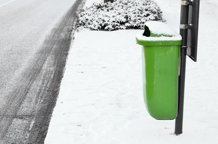 View of trash bin in city on winter dayの写真素材