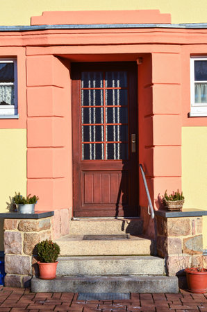 View of beautiful building with wooden door and stepsの写真素材