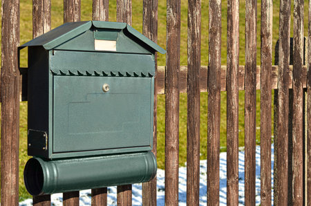 View of mailbox on wooden fenceの写真素材