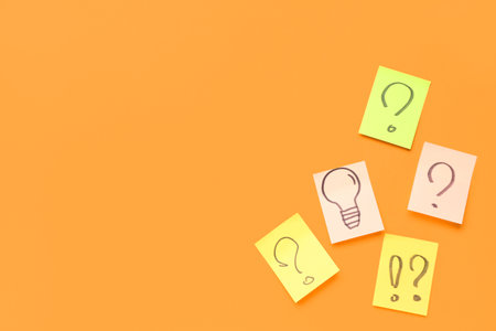 Sticky papers with drawn question marks and light bulb on red background. insight conceptの写真素材
