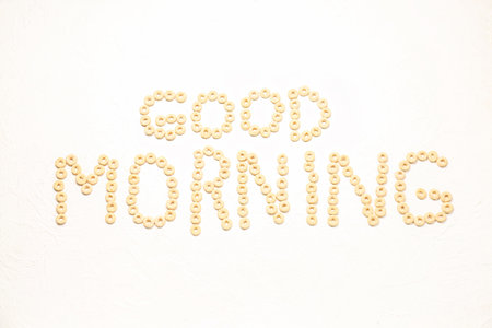 Text GOOD MORNING made of cereal rings on light backgroundの写真素材