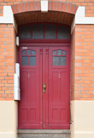 View of brick building with red wooden doorの写真素材