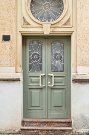View of old building with green wooden doorの写真素材