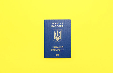Ukrainian passport on yellow background