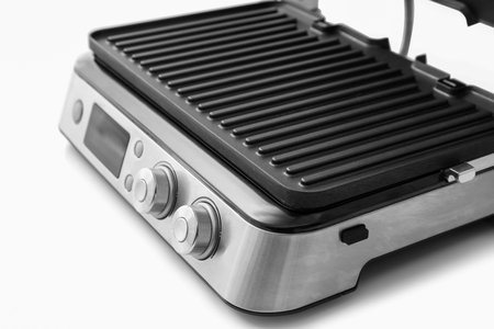Modern electric grill with open lid on white table, closeupの写真素材