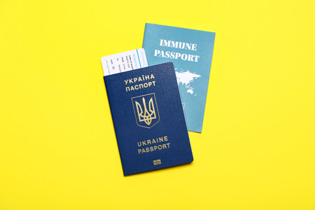 Ukrainian and immune passports on yellow backgroundの写真素材