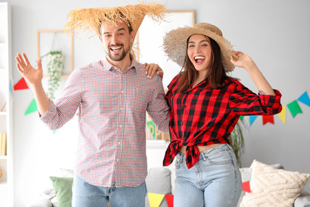 Young couple celebrating Festa Junina (June Festival) at homeの写真素材
