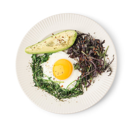 Plate with tasty fried egg, avocado and greens on white backgroundの写真素材