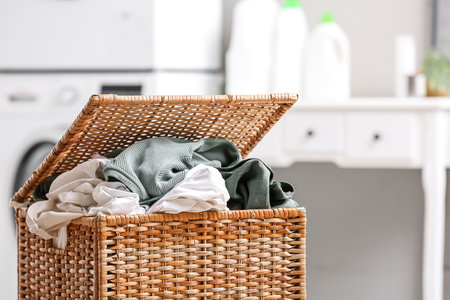 Basket with dirty clothes in laundry room, closeupの写真素材