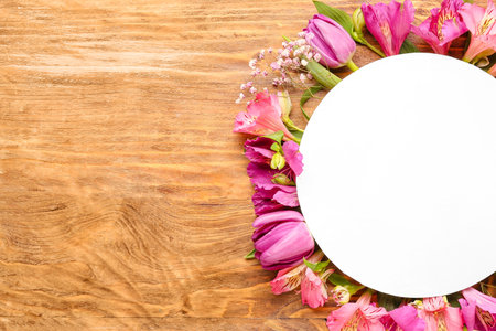 Blank card with pink flowers on wooden backgroundの写真素材