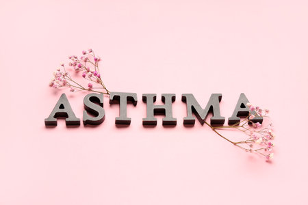Word ASTHMA with flowers on pink backgroundの写真素材