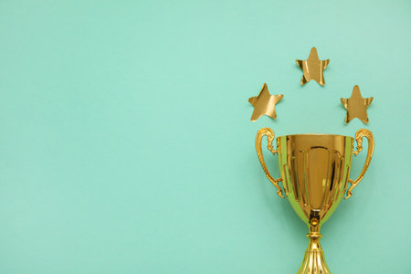 Gold cup with stars on mint backgroundの写真素材