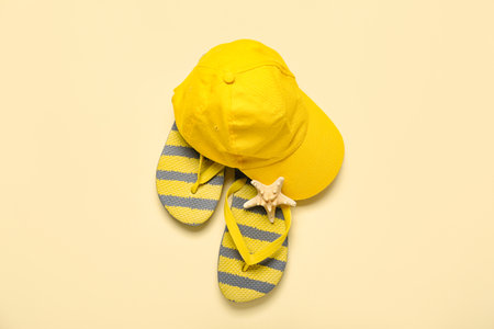 Flip-flops with cap on beige backgroundの写真素材