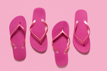 Flip-flops on pink background, top viewの写真素材