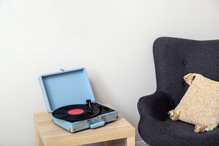 Record player with vinyl disk on table in living roomの写真素材