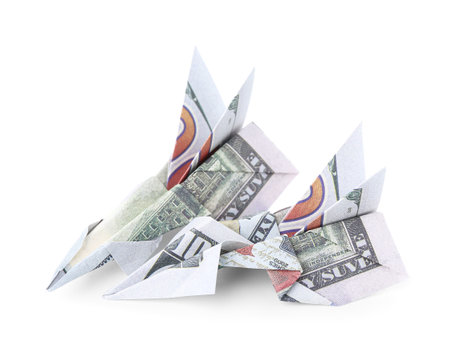 Origami airplanes made of dollar banknotes on white backgroundの写真素材