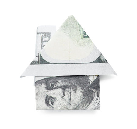 Origami house made of dollar banknotes on white backgroundの写真素材