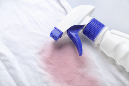 Laundry detergent with stained clothes on light background, closeupの写真素材