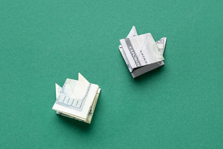 Origami cats made of dollar banknotes on green backgroundの写真素材