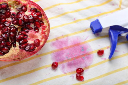 Laundry detergent with pomegranate on stained clothes, closeupの写真素材