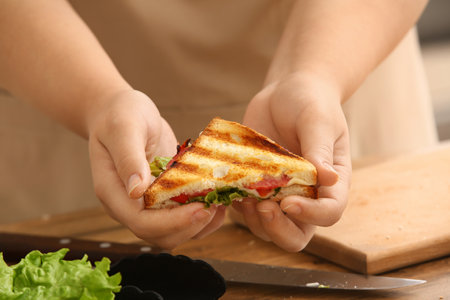Woman holding delicious grilled sandwich, closeupの写真素材