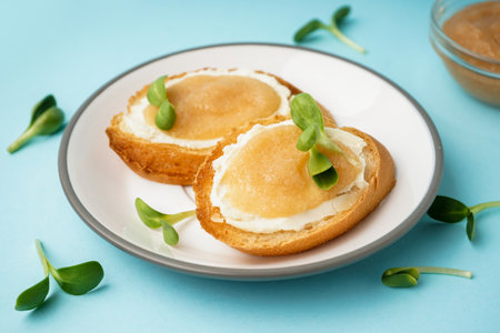 Delicious canape with caviar of capelin and microgreen on blue backgroundの写真素材