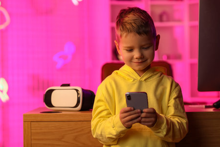Cute little blogger using mobile phone at home