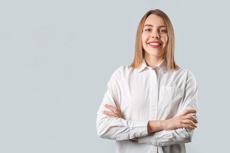 Female business consultant on gray backgroundの写真素材