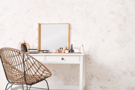 Table with mirror and decorative cosmetics in modern makeup roomの写真素材