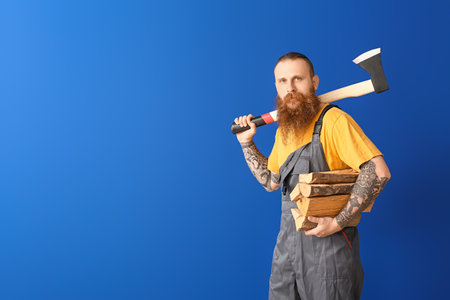 Handsome lumberjack on color backgroundの写真素材