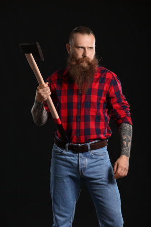 Handsome lumberjack on dark backgroundの写真素材