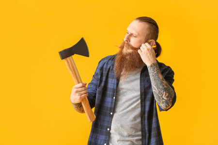 Handsome lumberjack on color backgroundの写真素材
