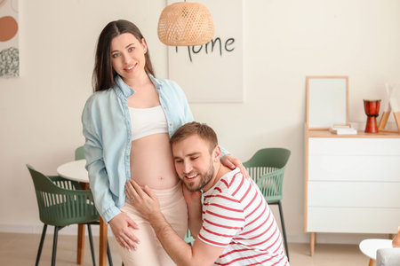 Beautiful pregnant woman with her husband at home