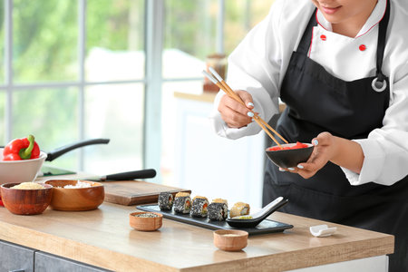 Beautiful Asian chef cooking in the kitchenの写真素材