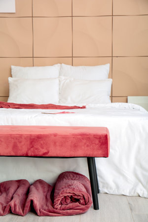 Big bed and bench in interior of modern roomの写真素材