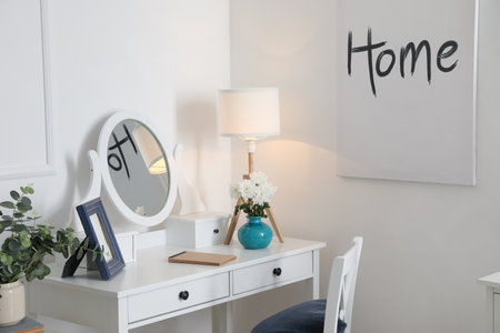 Stylish dressing table with glowing lamp at homeの写真素材