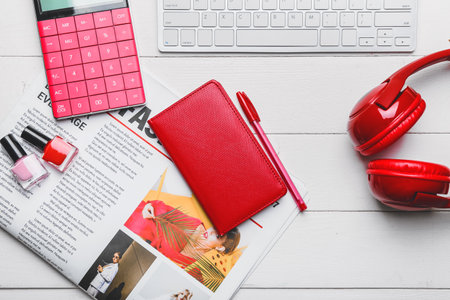 Computer keyboard with headphones, newspaper and stationery on tableの写真素材